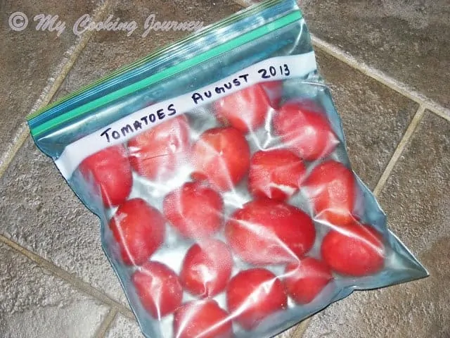 frozen tomatoes in a labeled freezer bag