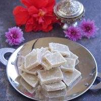 Maida Burfi for Diwali with flowers in the background