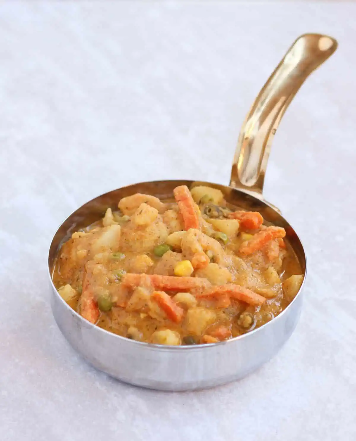 Mixed vegetable curry in a serving bowl. 