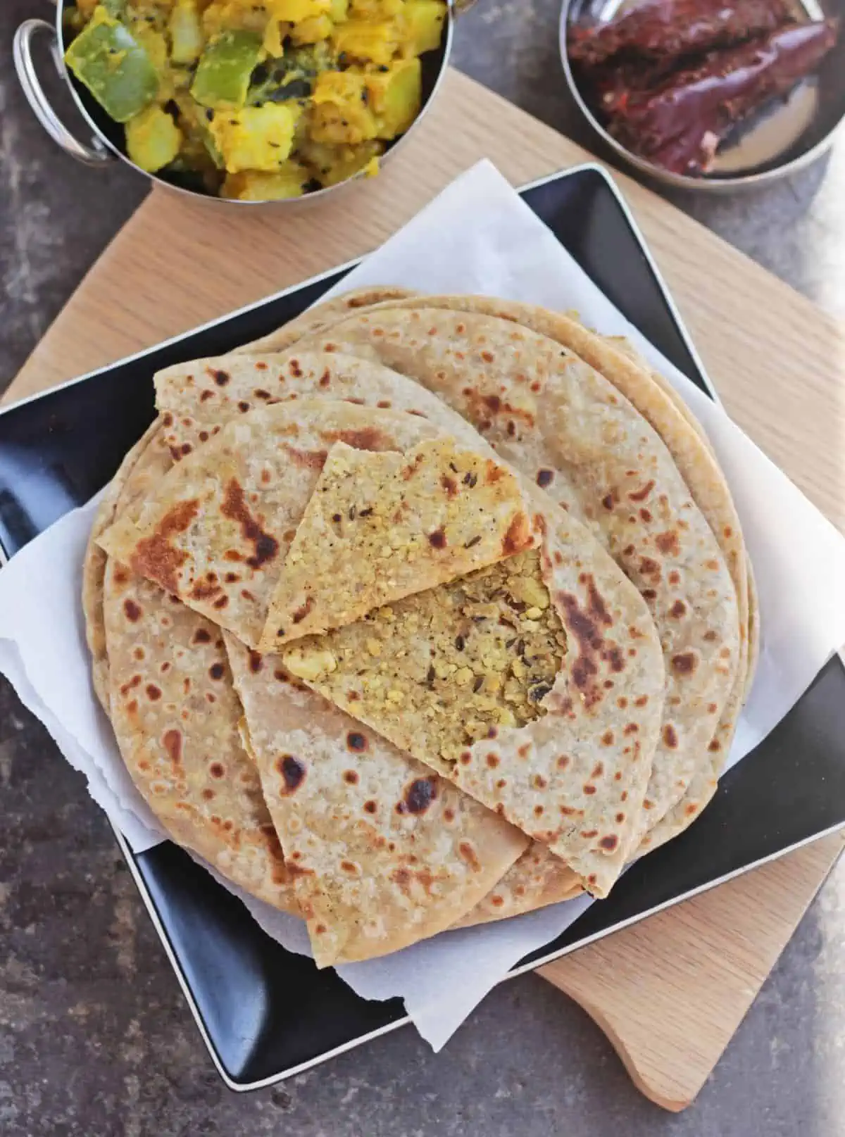 Layers of paratha with the top one showing a stuffed lentil filling.