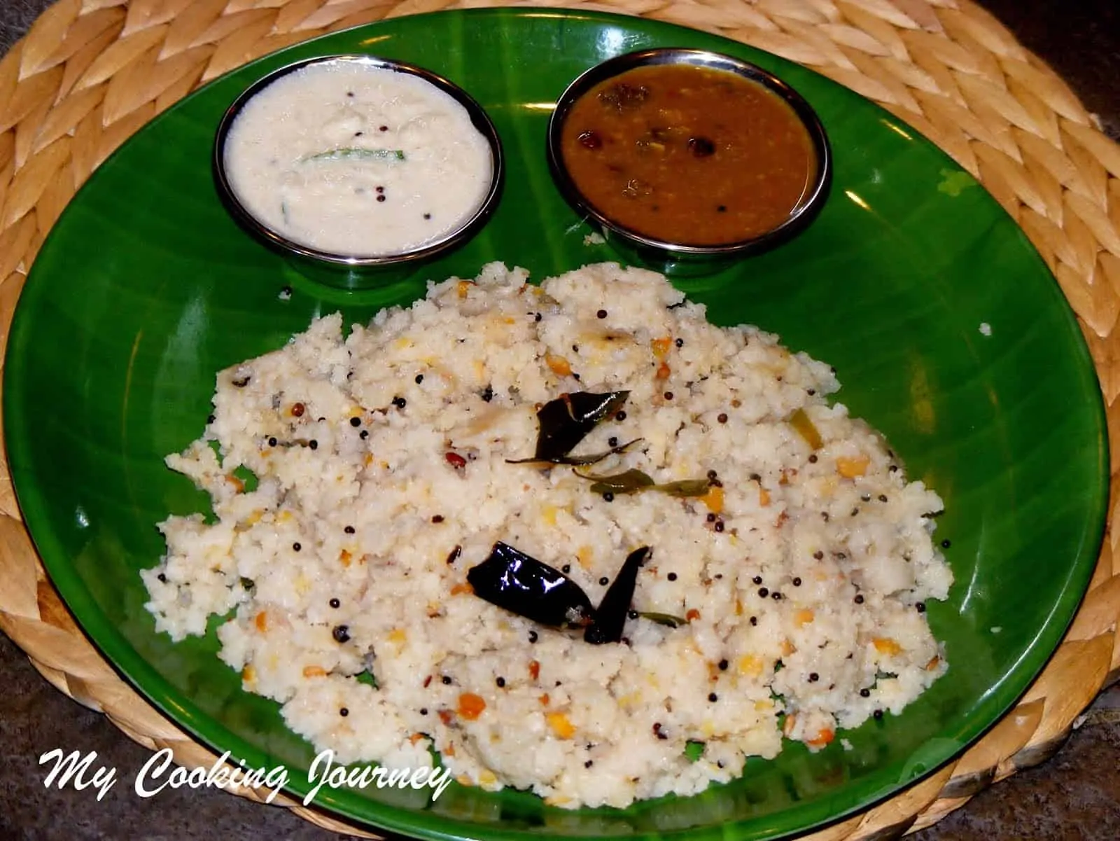 Arisi Upma in a plate with chutney and sambar.