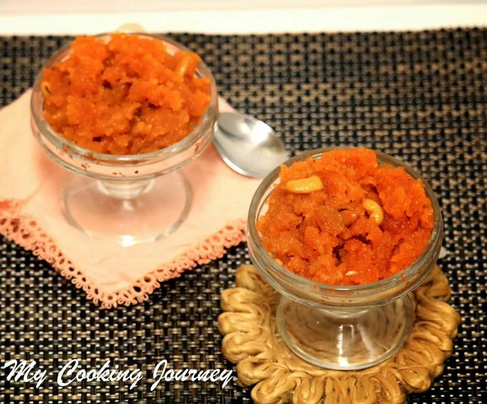 Aval Kesari in 2 glass bowls with spoon on the side.