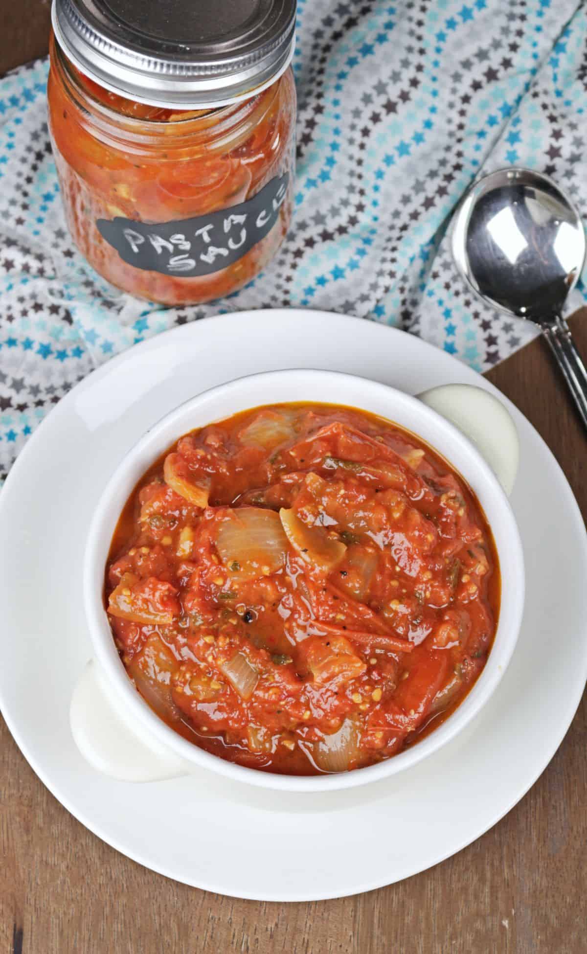 roasted tomato pasta sauce in a white bowl and a mason jar