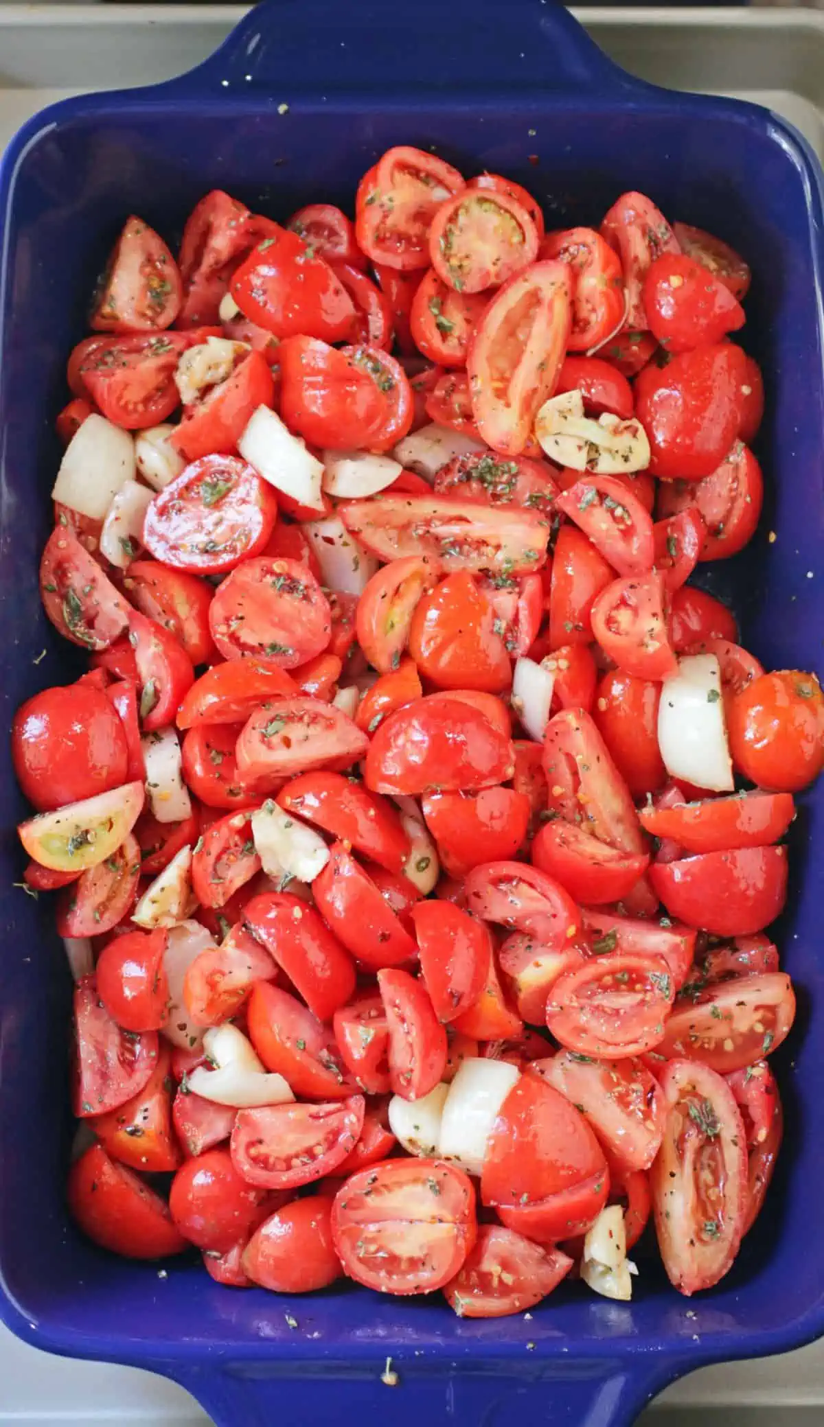 tomato onion and spices in a baking tray