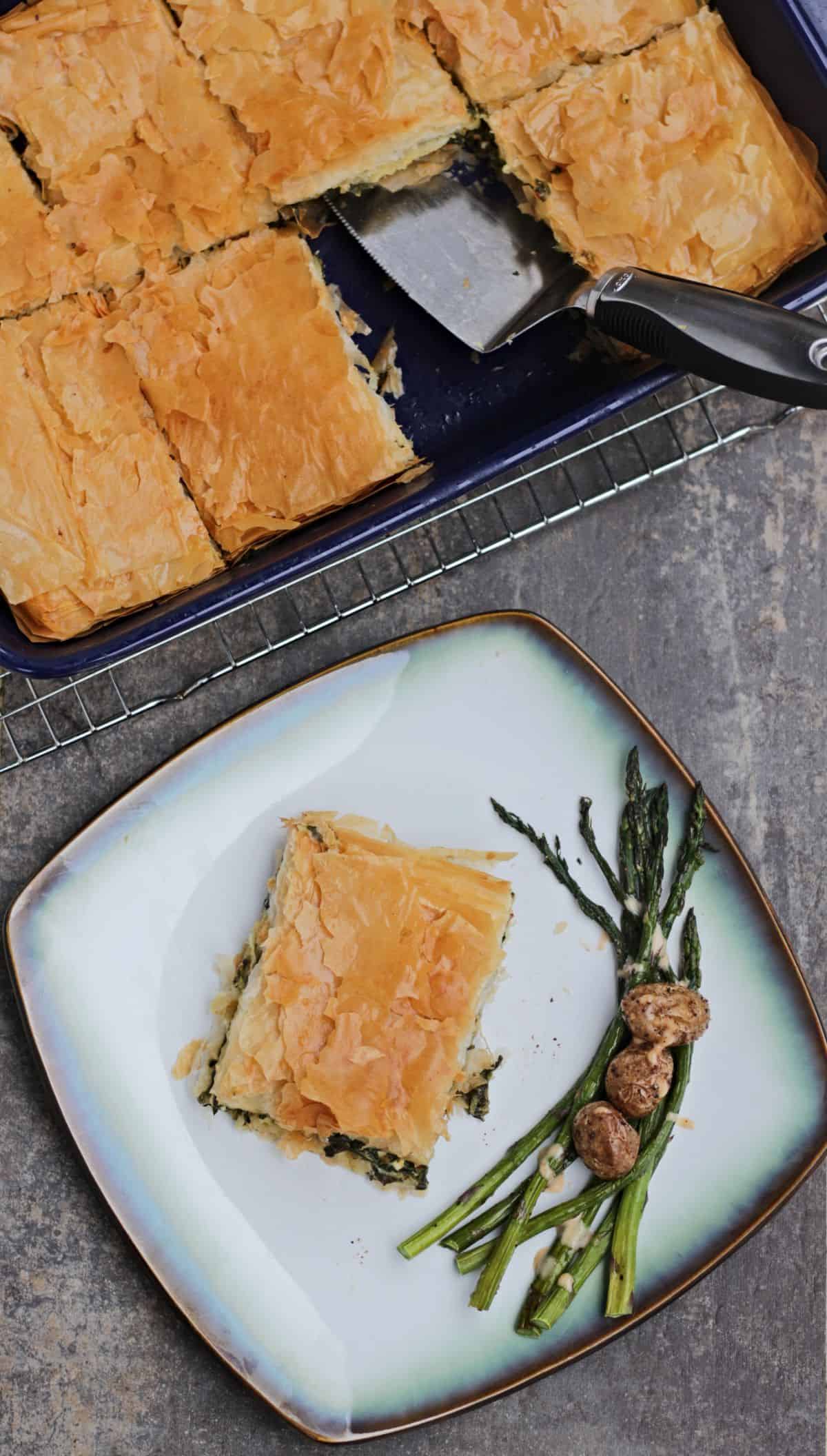 spinach pie in a plate with sides and in a baking tray