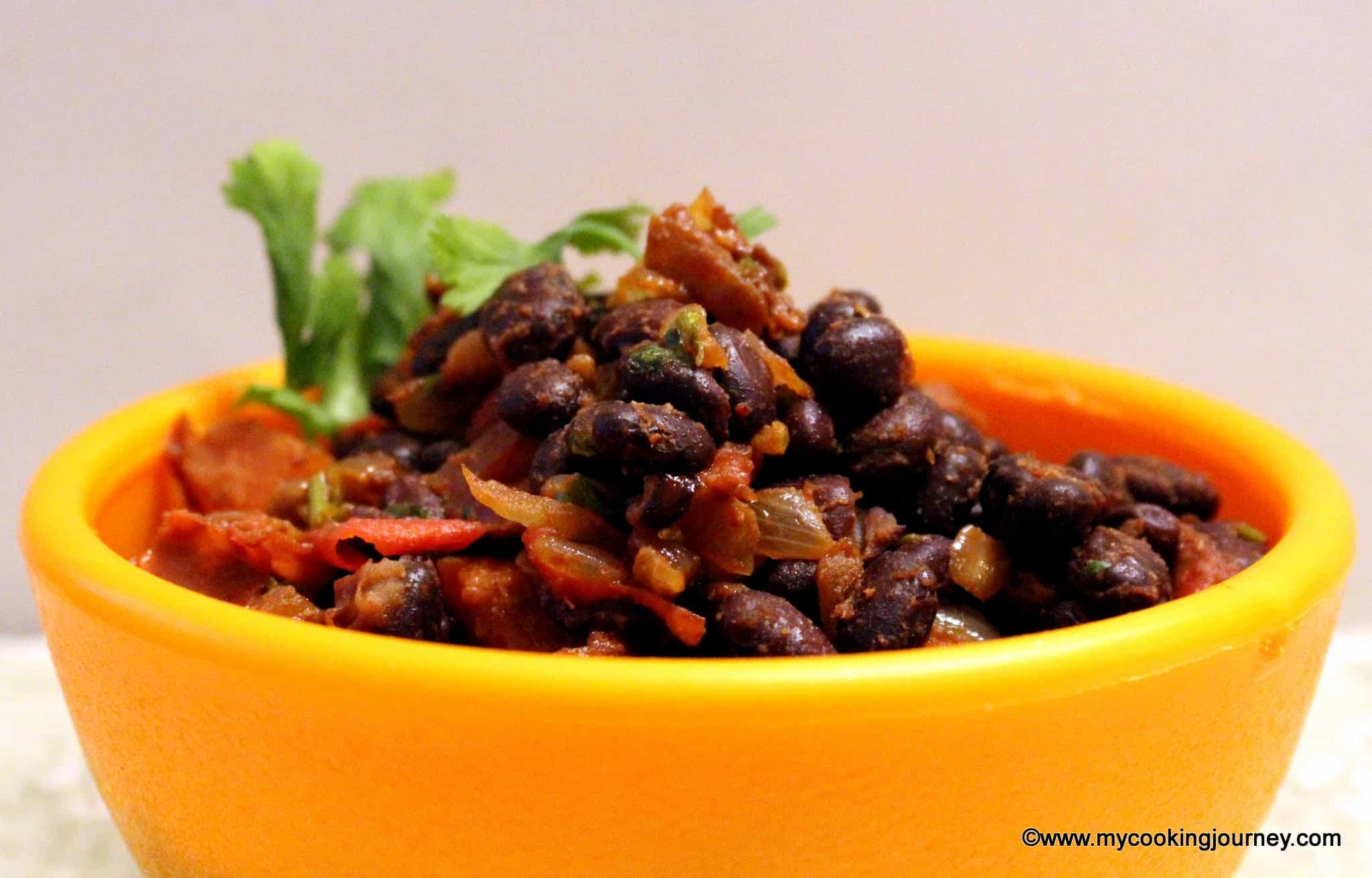 Warm black bean salad in a yellow bowl