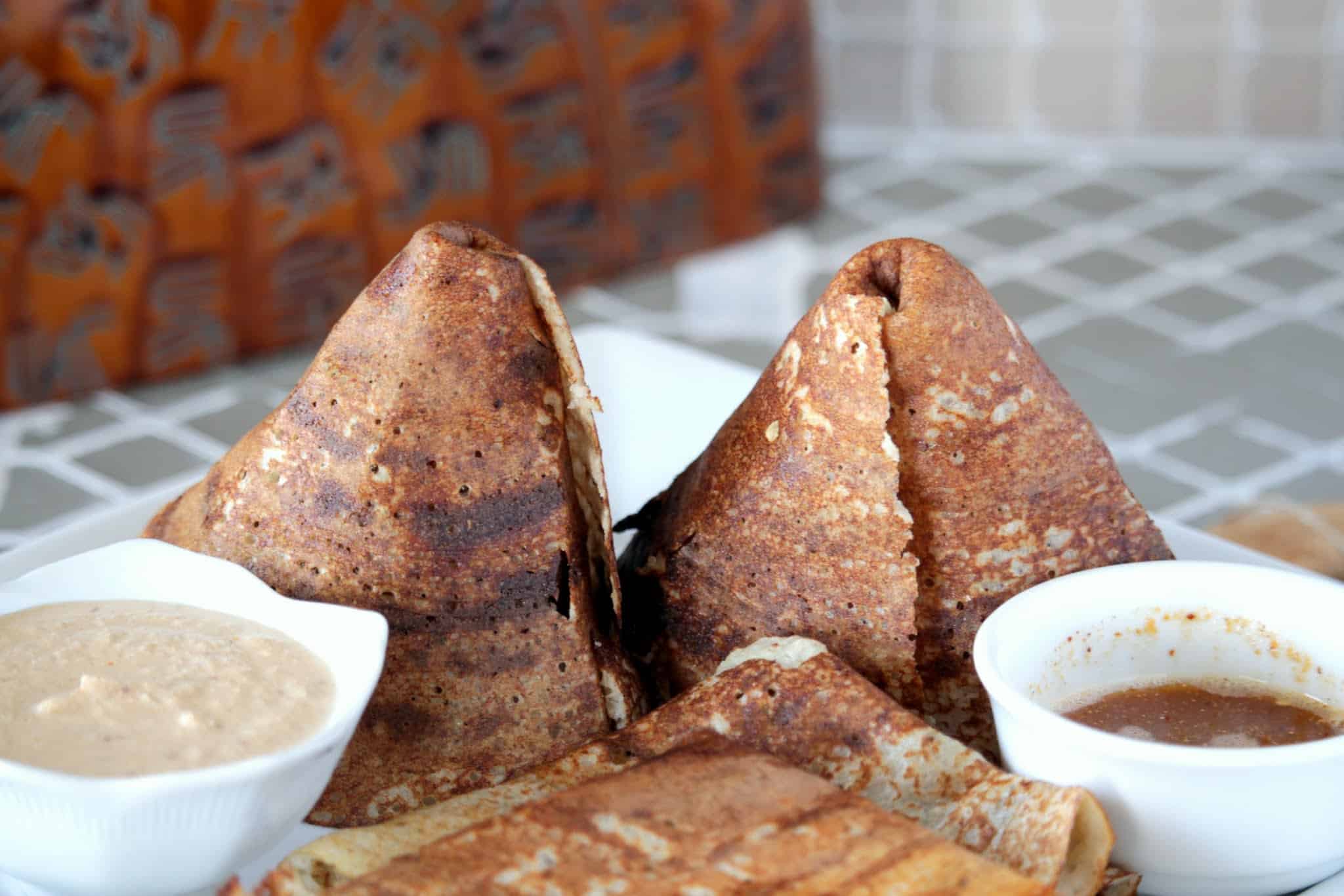 quinoa crepes in a plate with chutney and sambar