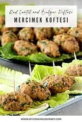 Turkish kofte arranged on a lettuce with toothpicks and more in the background.