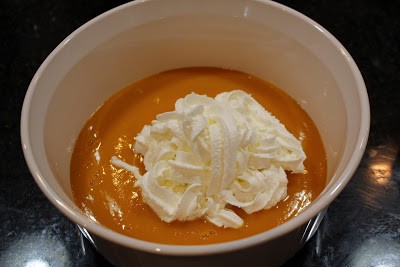 Mango pulp and whipped cream in a bowl.
