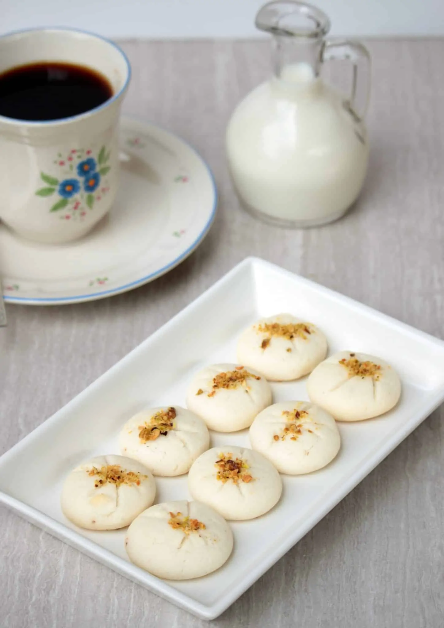 Persian Rice Flour Cookies in a plate with coffee in the background