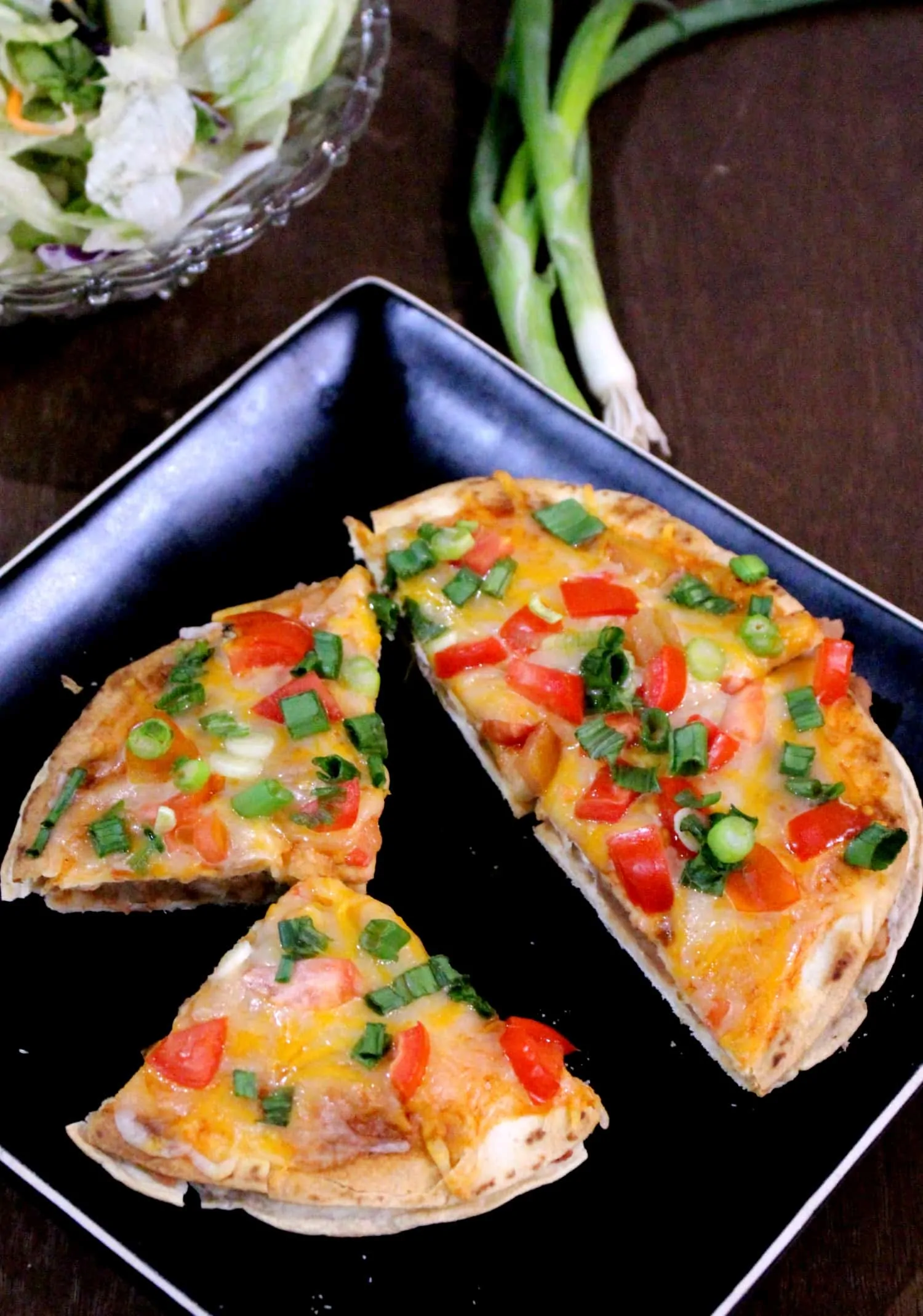 Taco Bell Style Vegetarian Mexican Pizza is served in a black dish