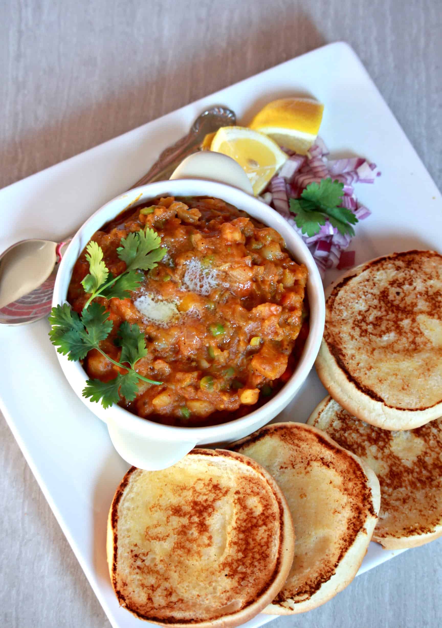 Pav Bhaji served with pav and onion pieces on the side