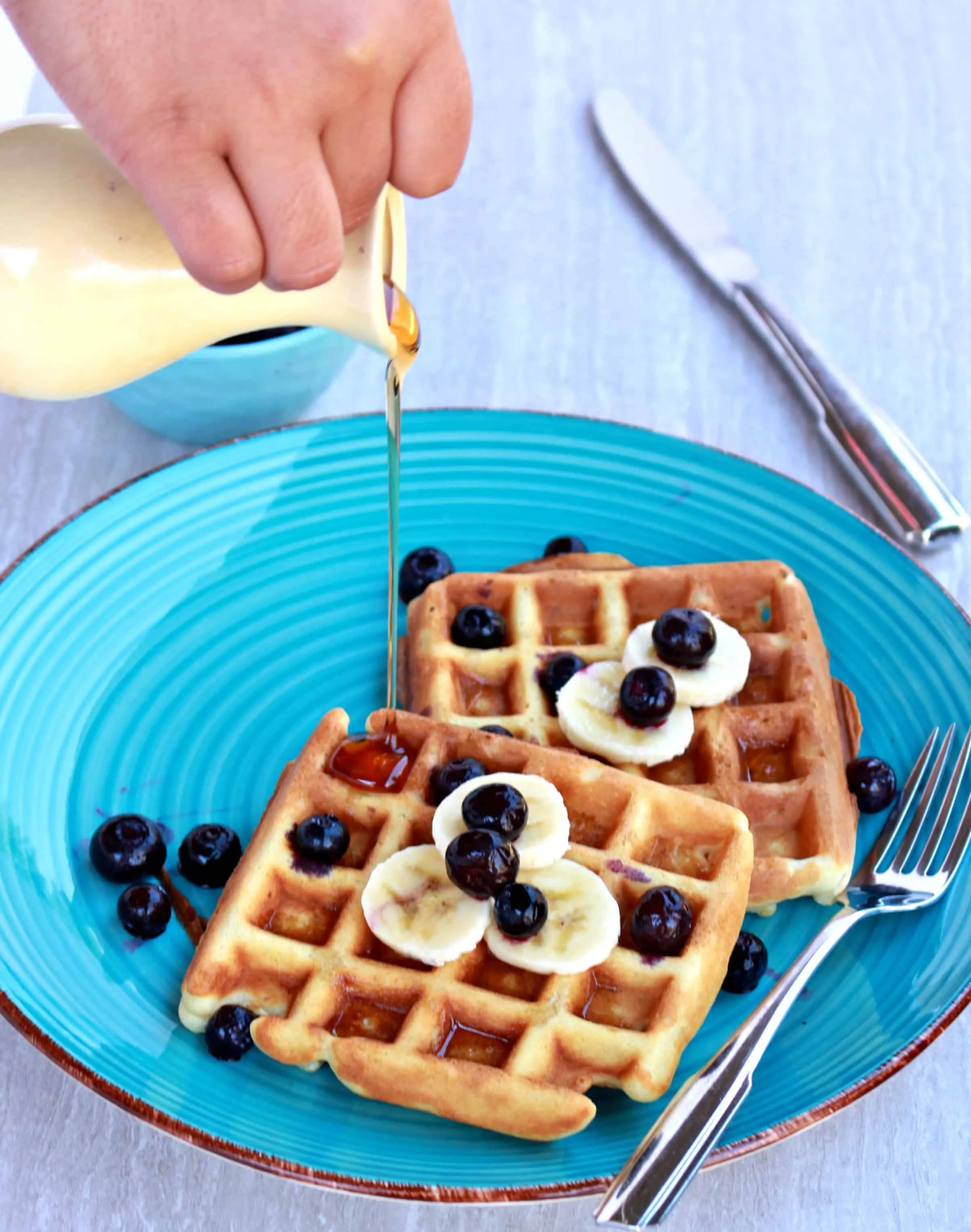 Pouring syrup on Waffles