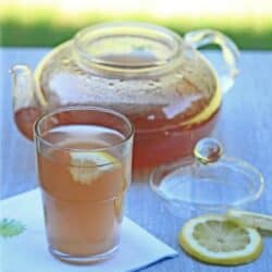 barley tea in a glass and a tea pot with lemon slice