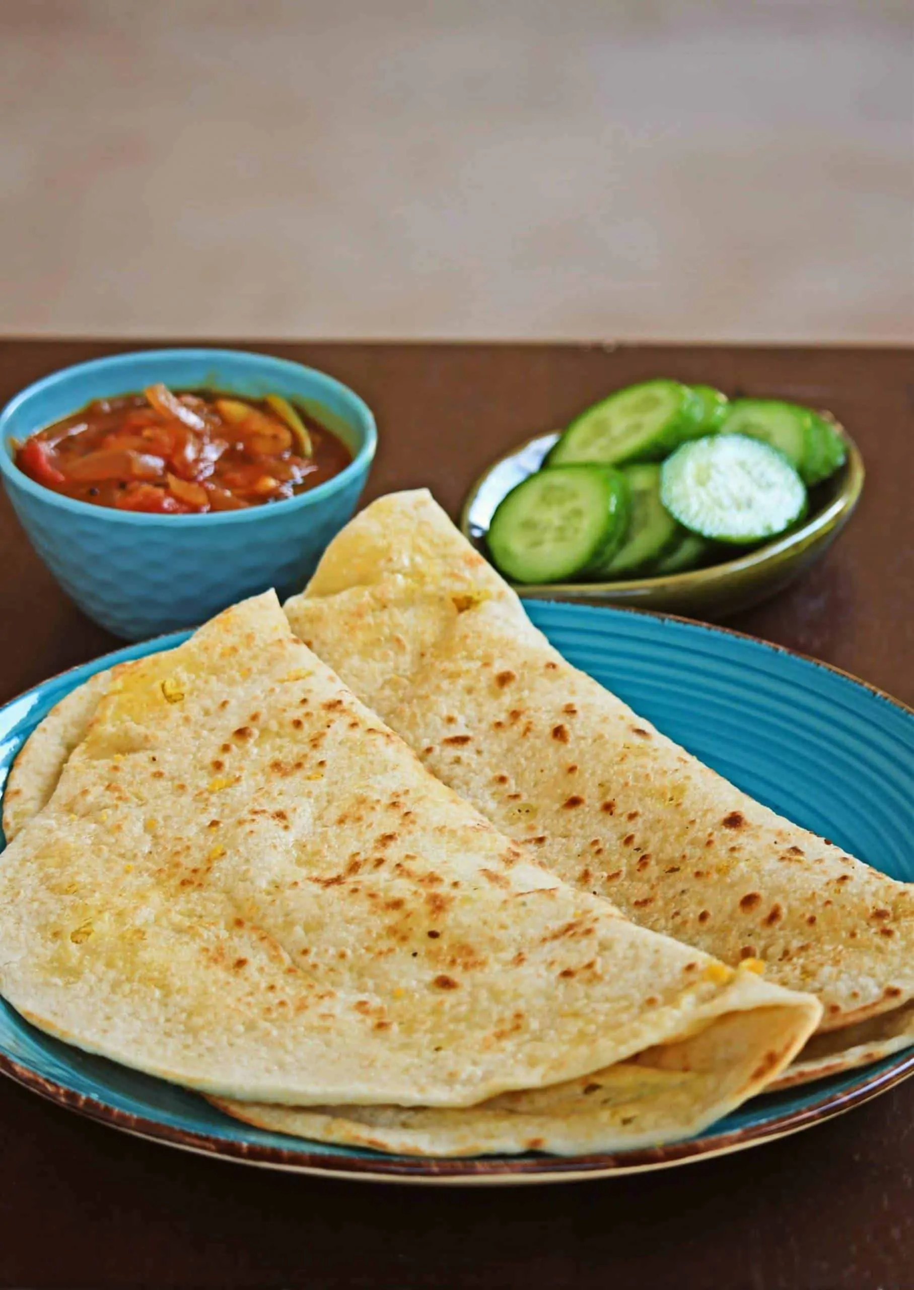 Dhal Puri in a blue plate with sides
