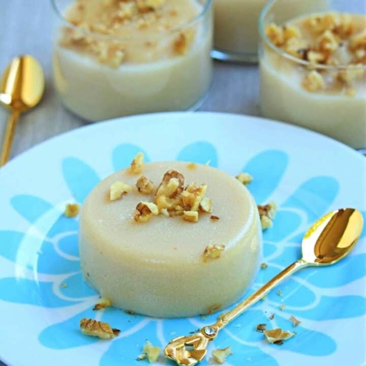 turkish semolina pudding in a plate with a golden spoon