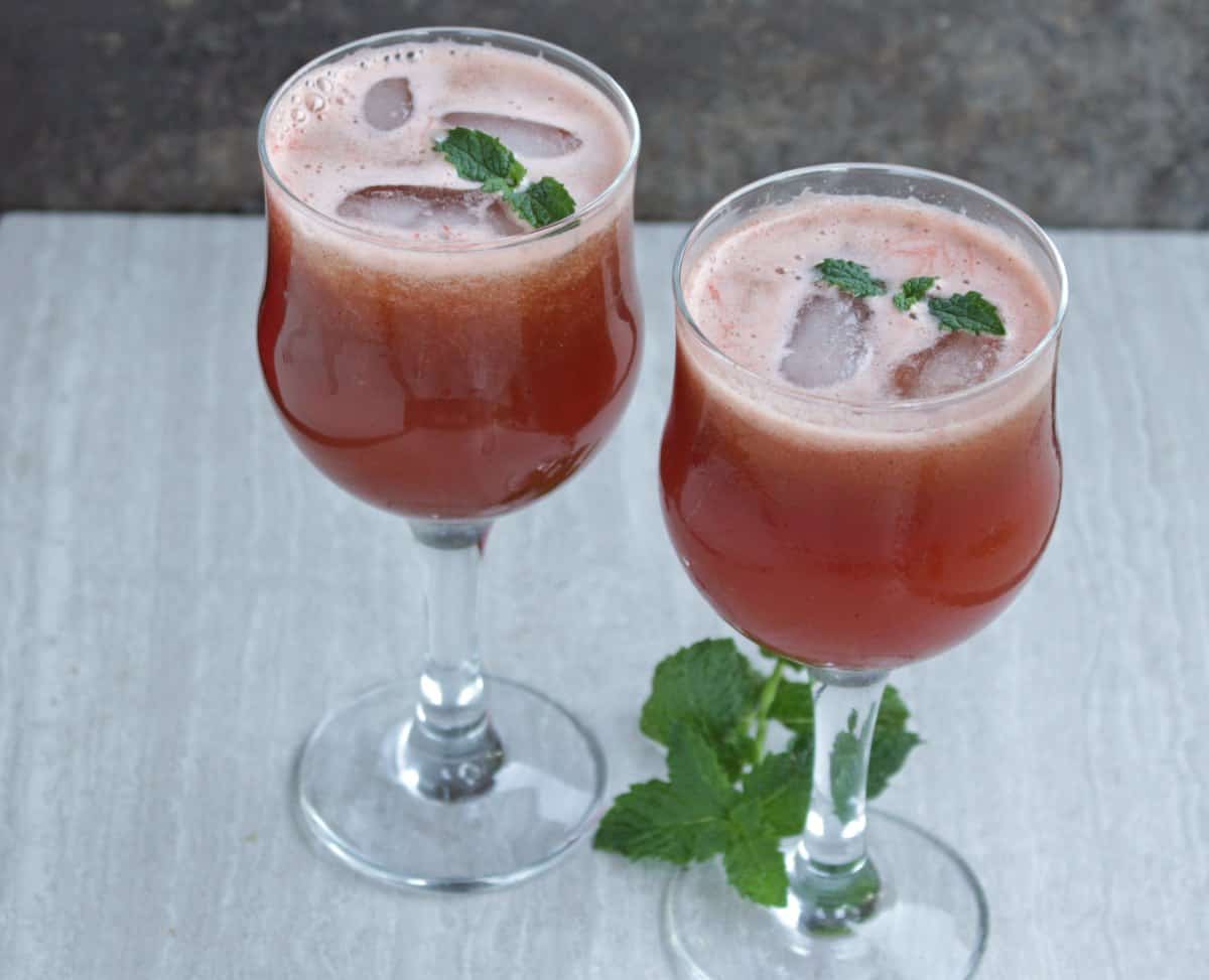 Spiced Watermelon and Mint Juice with mint as garnish.