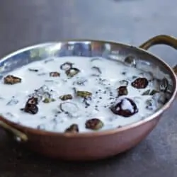 Air fried okra in yogurt served in copper bowl