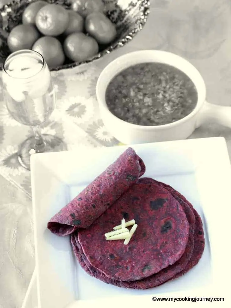 Beetroot Paratha's in a white plate with subzi on the side