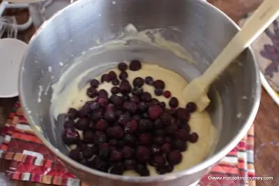 Mixing blueberries with batter