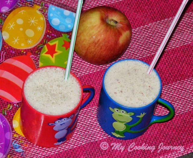 Apple smoothie in a cup with straw