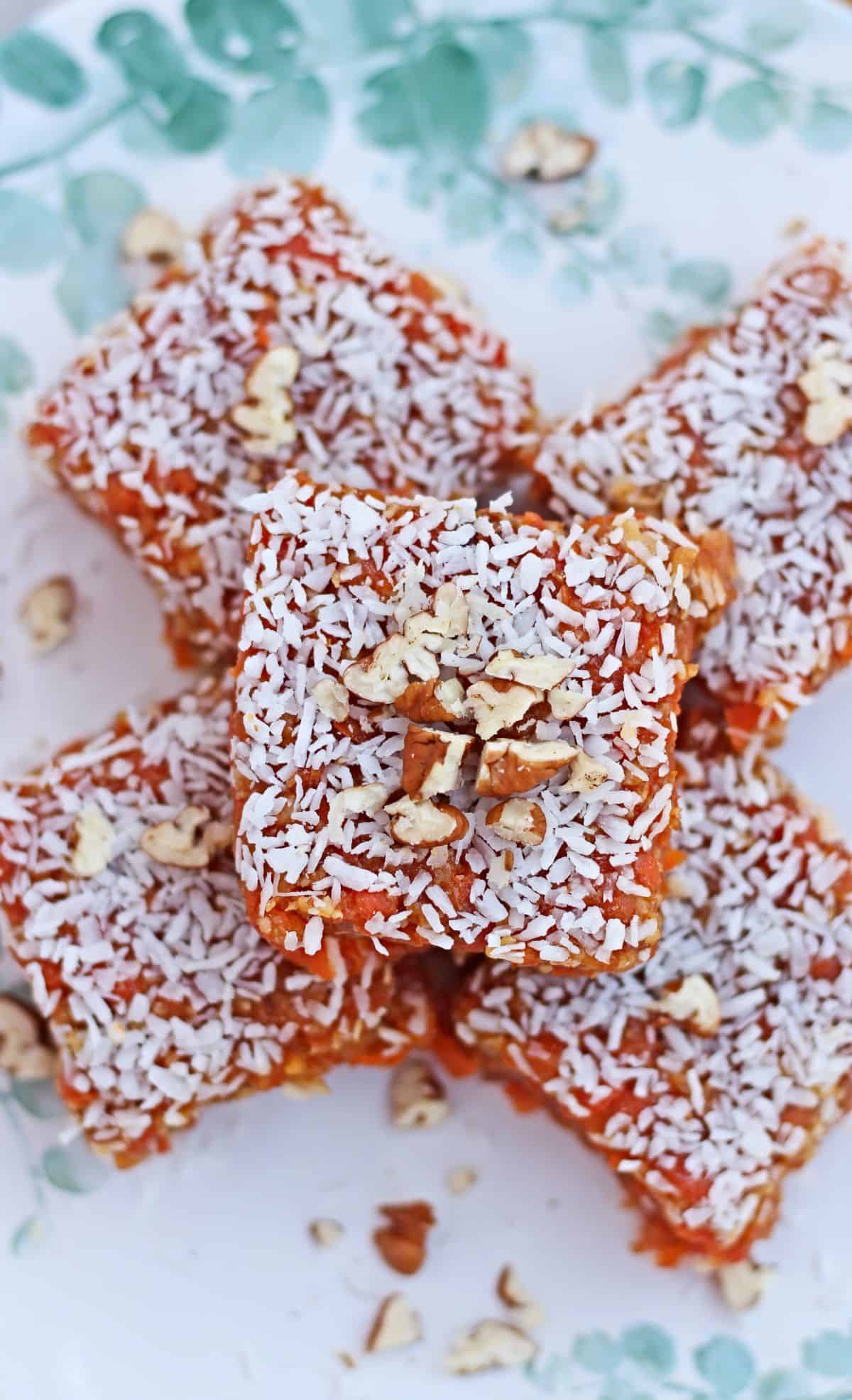 Cezerye slices in a plate garnished with coconut and nuts