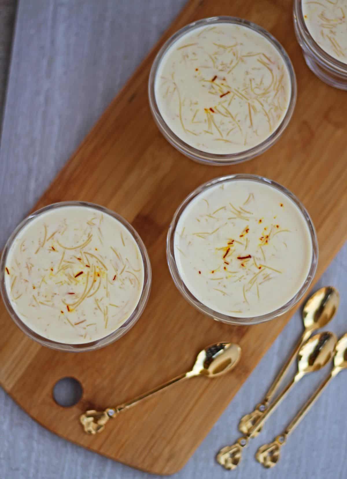 Semiya payasam with saffron on top and spoons on the side