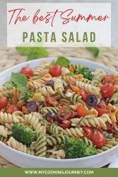 Pasta salad with rotini and vegetables and text on top.