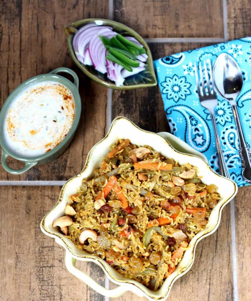Vegetable Biriyani served with salad in the background