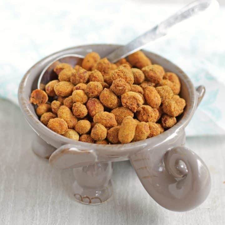 spicy peanuts in a elephant shape bowl with spoon