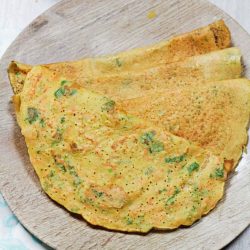 dosa stacked in a wooden plate
