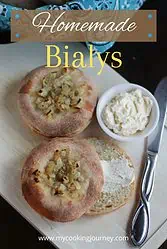 Two bialys sliced with text.