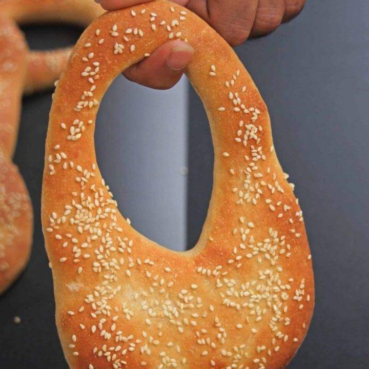 Kaak bread hanging from a finger - feature image