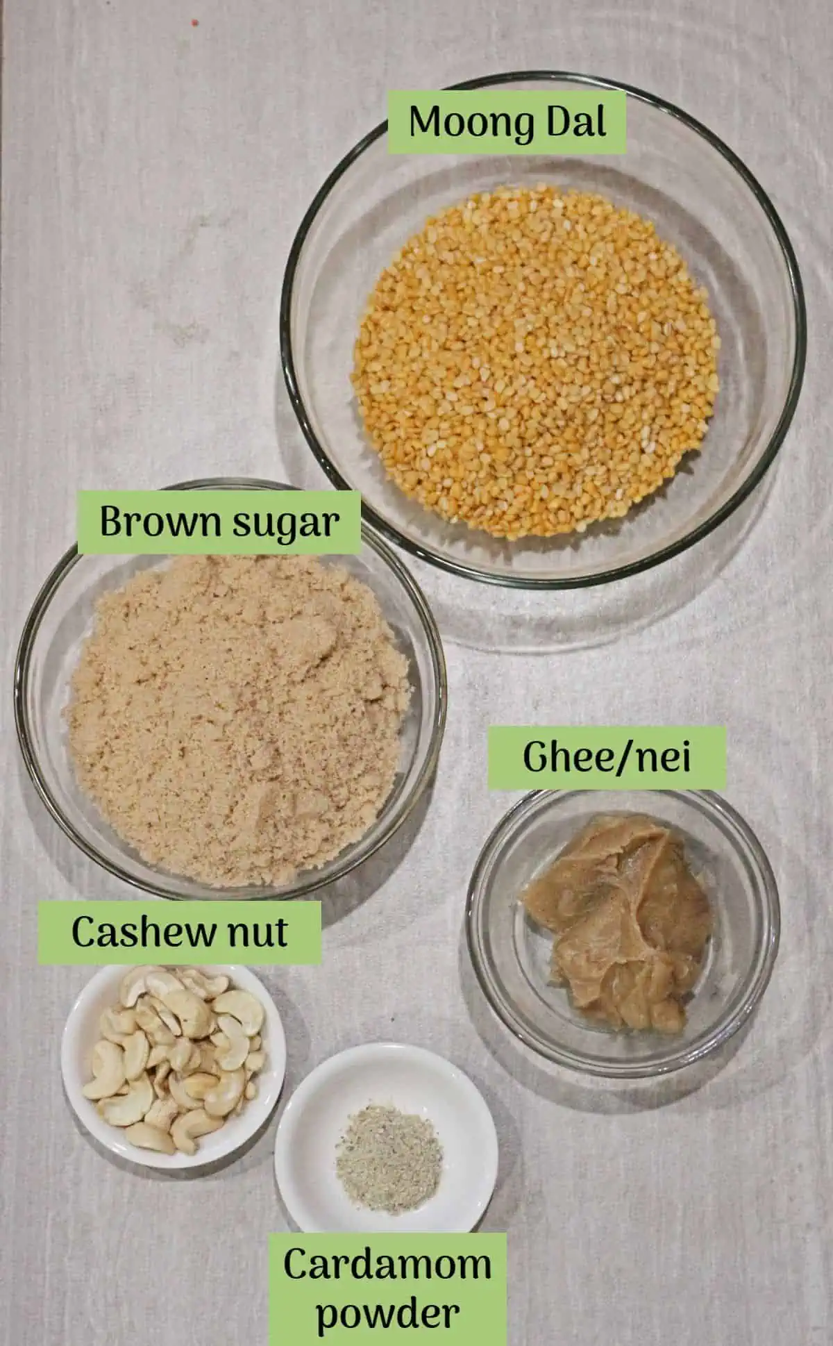 Ingredients needed to make nei urundal / moong dal laoo.