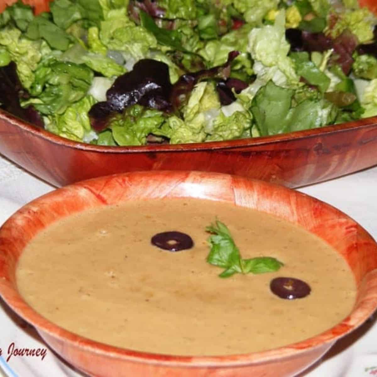 Asian Style salad dressing in a bowl with salad on the side - Featured Image