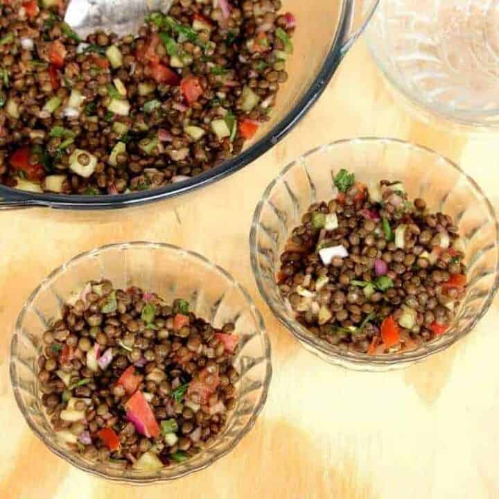 French Green Lentil Salad in two small bowl with a large one on the side - Featured Image.