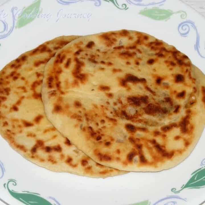 Amritsari Kulcha in a white plate - Featured Image