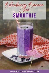 Purple blueberry and banana smoothie in a tall glass with text