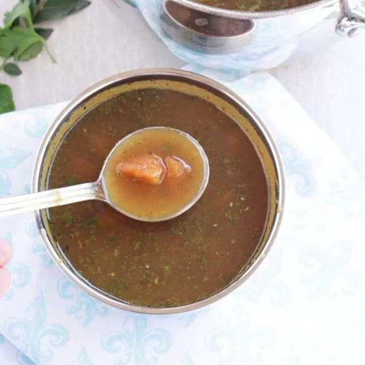 Muligatwawany Soup in a bowl with a spoon - Featured Image.