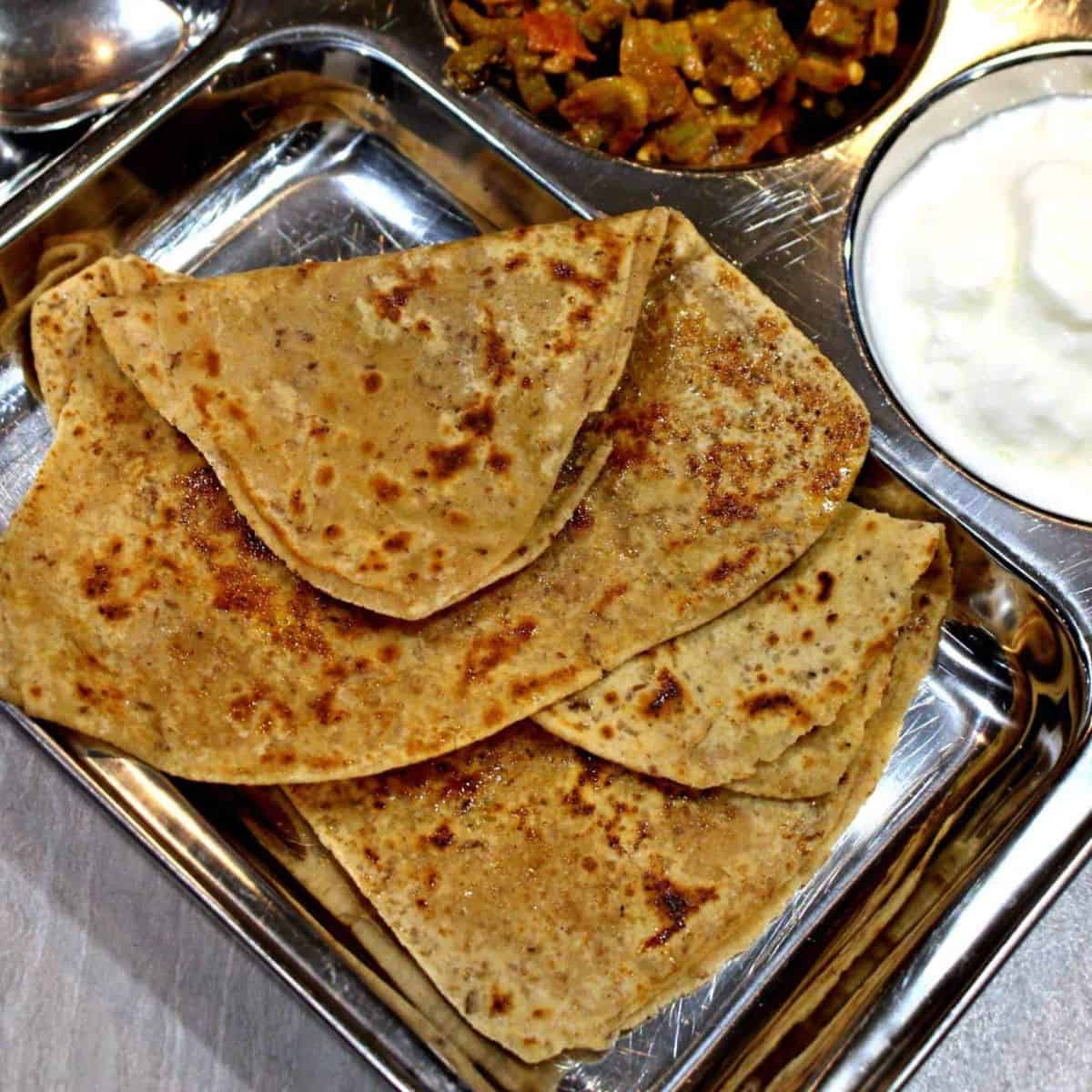 Sweet Paratha in a Stainless Steel Plate - Featured Image