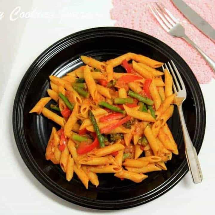 Pasta Primavera in a black plate with a fork - Featured Image