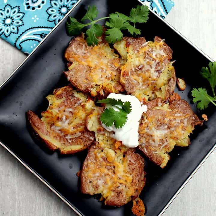 Smashed Potatoes in a black plate - Featured Image