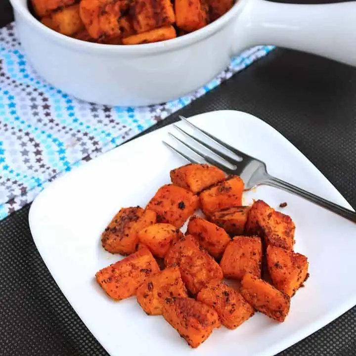 Spicy Oven Roasted Sweet Potatoes in a white plate - Featured Image