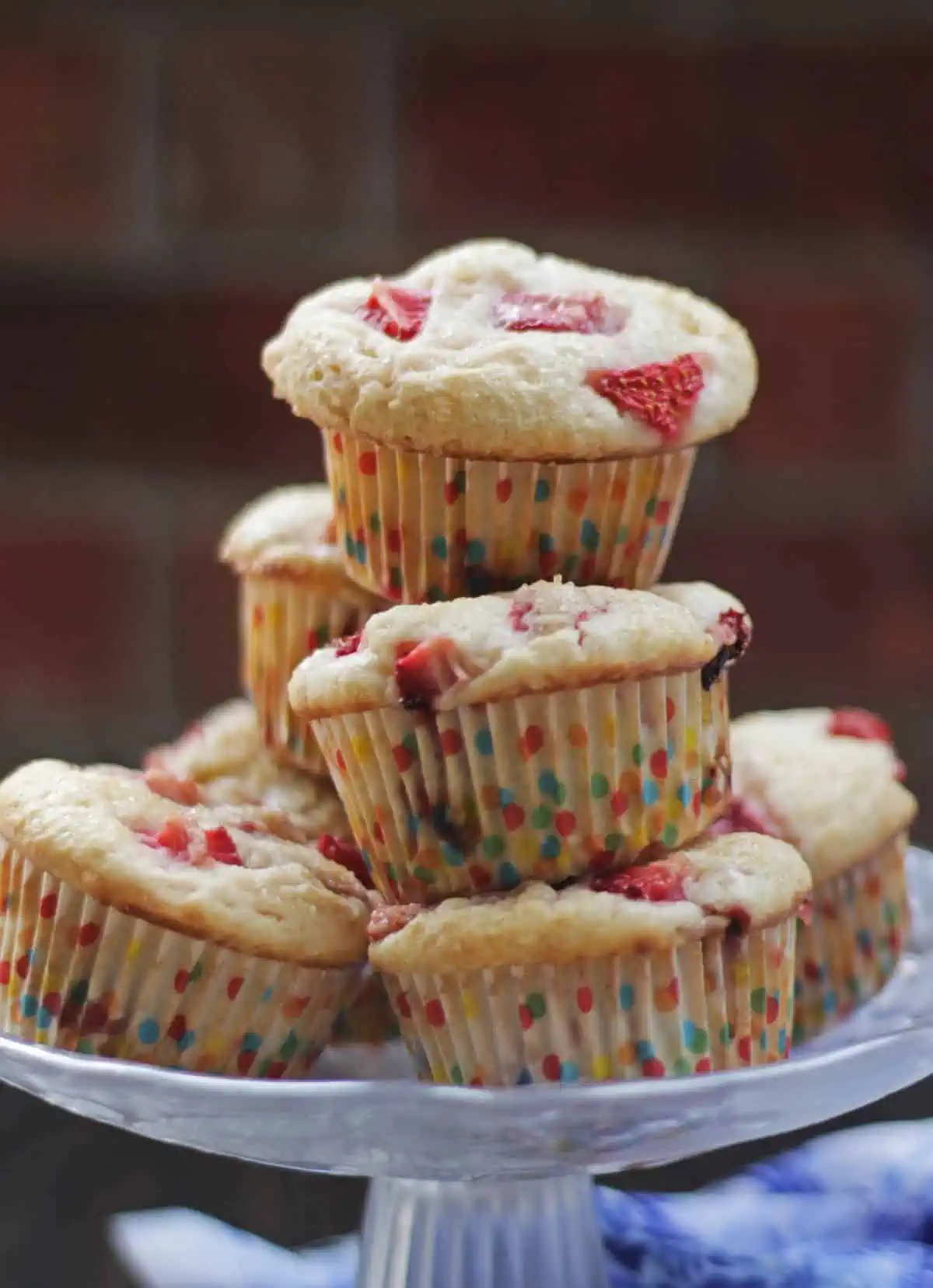 Strawberry muffins stacked in a glass plate. 