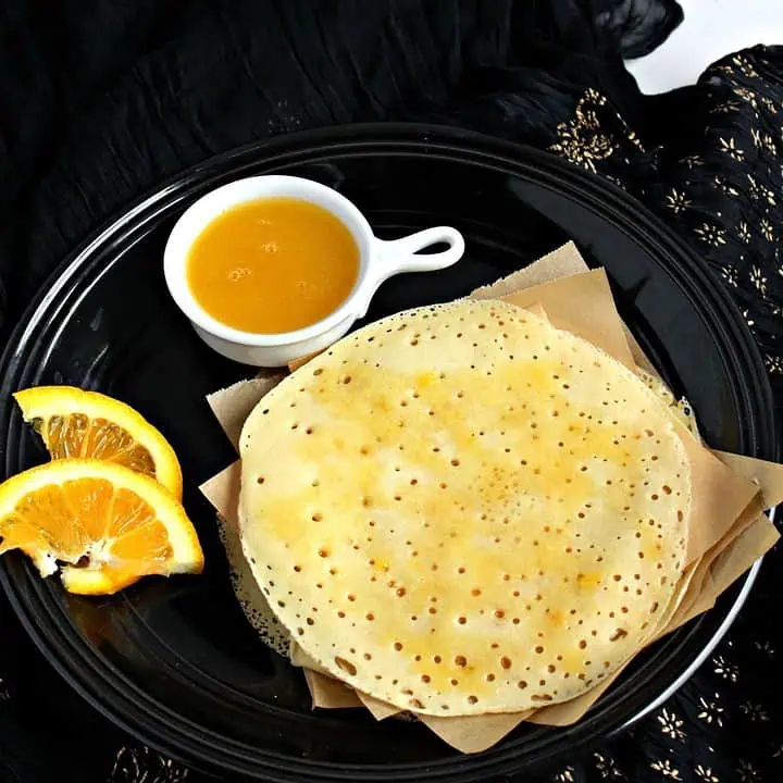 Baghrir with orange sauce on the side - Featured Image.