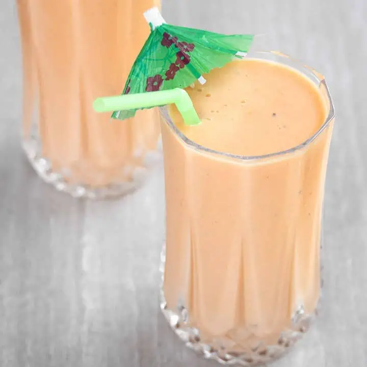 Papaya Lassi in glass cups with straw - Featured Image