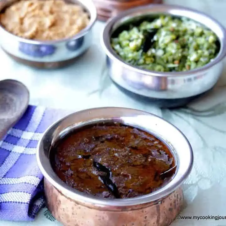 Milagu Kuzhambu with curry and thuvayal on the side - Featured Image