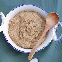 Ridge gourd thogayal in a bowl with a spoon on top.