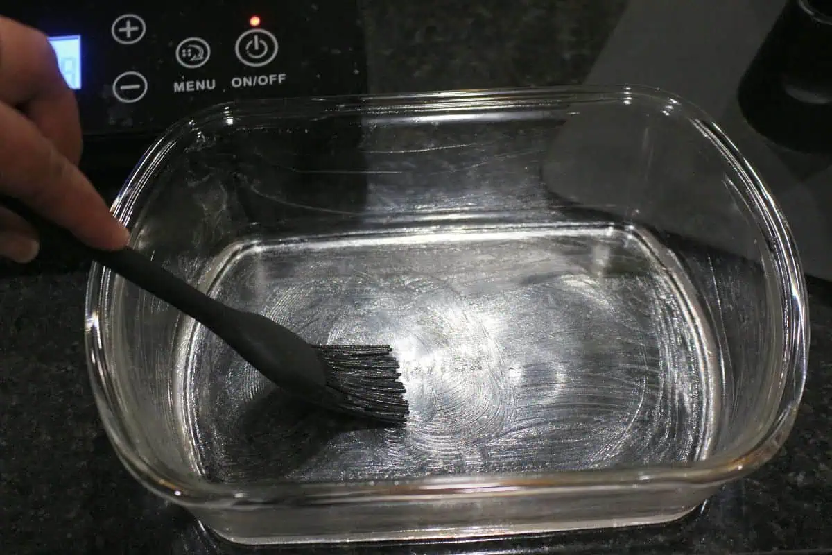 greasing a tray to pour burfi.